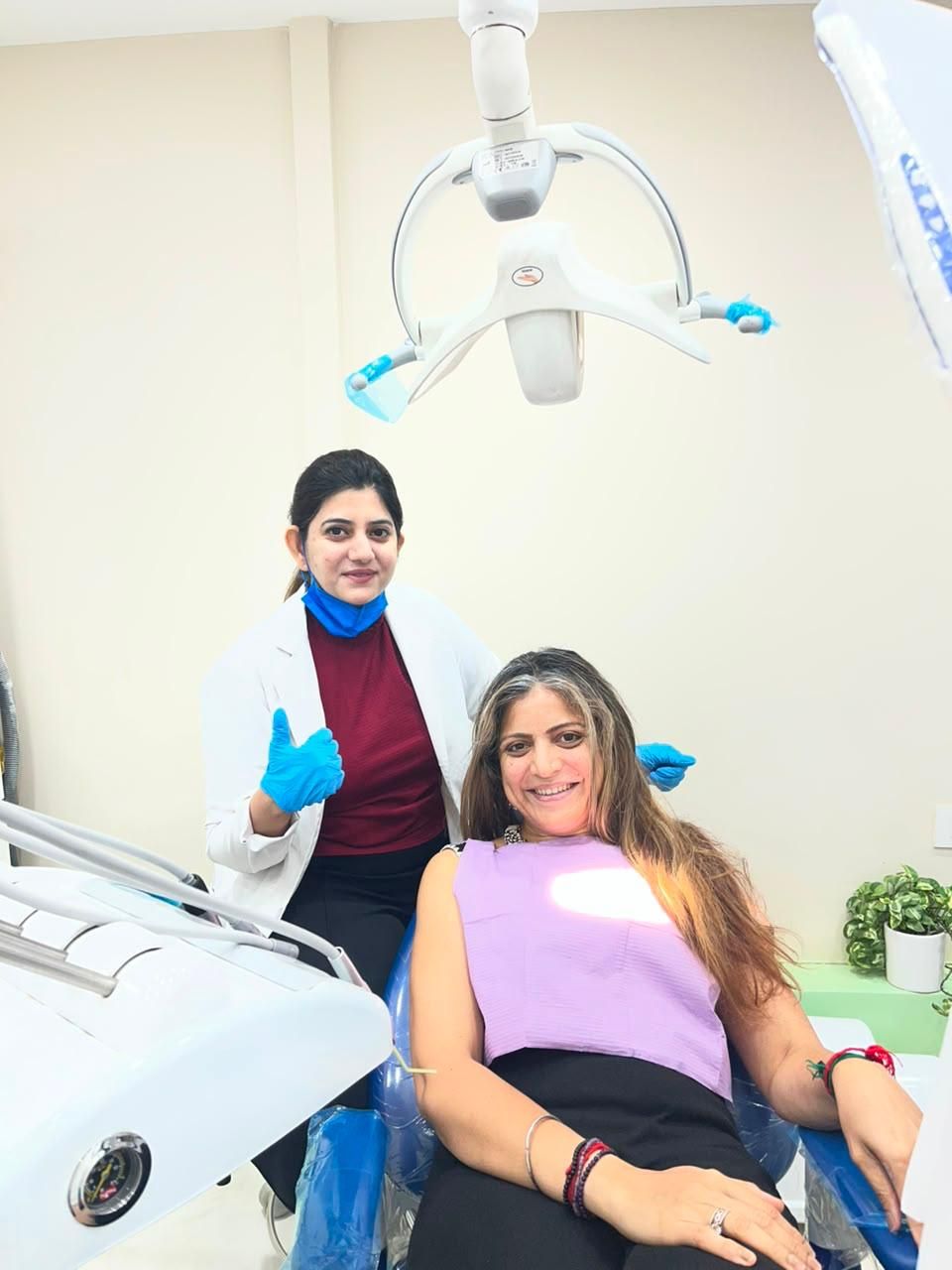 A patient smiling in the chair after treatment at Dentistaa, Sector 50